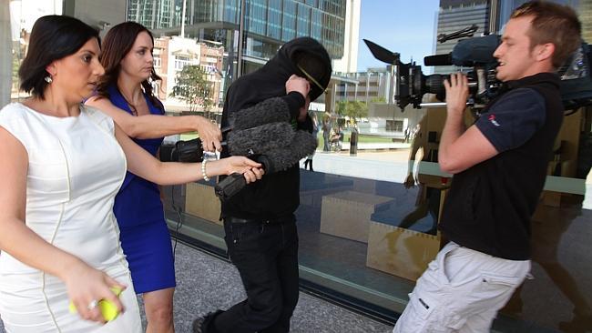 Wayne Charles Hartwig dodges the media outside court.