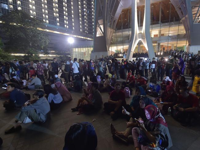 Indonesians gather to view the moon during a lunar eclipse in Jakarta. /Picture: AFP/Adek Berry