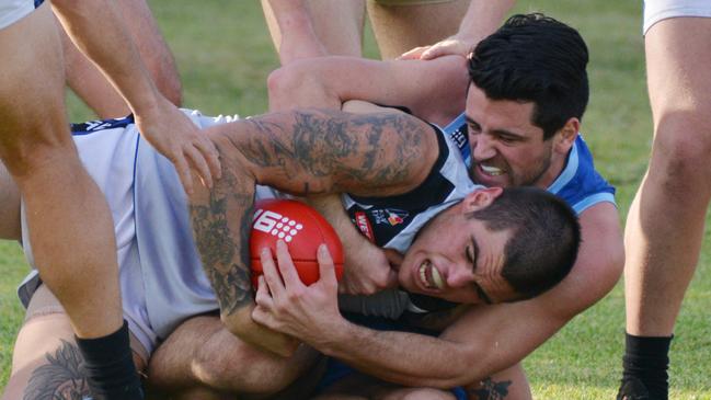 SHOC’s Michael Teal wraps up Unley’s Jye De Zylva on Saturday. Picture: AAP/Brenton Edwards