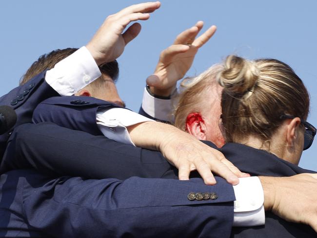 Former President Donald Trump is rushed offstage with a bloody ear during a rally in Butler, Pennsylvania. Picture: Getty Images