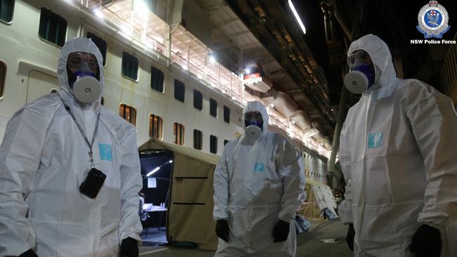 NSW Police wearing hazmat suits board the Ruby Princess cruise ship at Port Kembla on Wednesday night. Picture: NSW Police