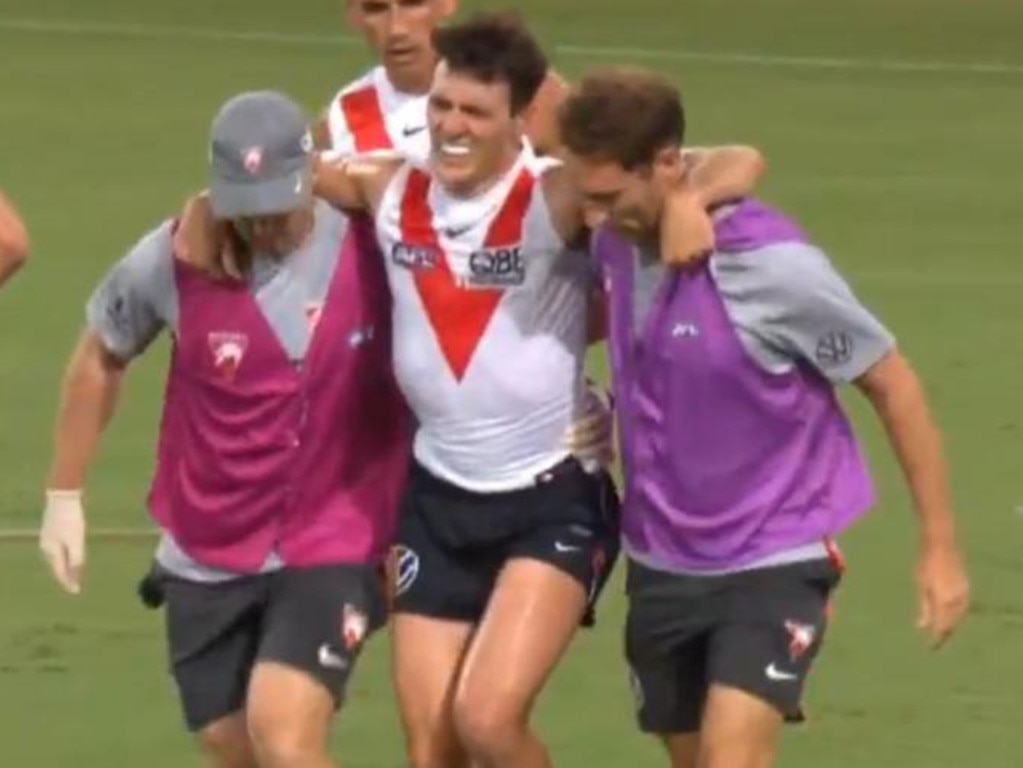 Errol Gulden is helped from the field after injuring his ankle