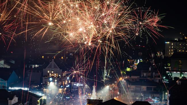 Pro-democracy protesters in a rally and revellers gather at the promenade of Tsim Sha Tsui district as fireworks explode over Hong Kong on January 1, 2020. Picture: Philip Fong/AFP