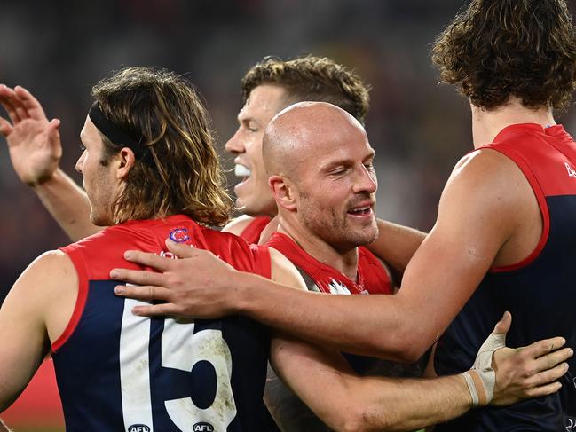 MELBOURNE, AUSTRALIA - APRIL 24: Nathan Jones and his  Demons team mates celebrate winning the round six AFL match between the Melbourne Demons and the Richmond Tigers at Melbourne Cricket Ground on April 24, 2021 in Melbourne, Australia. (Photo by Quinn Rooney/Getty Images)