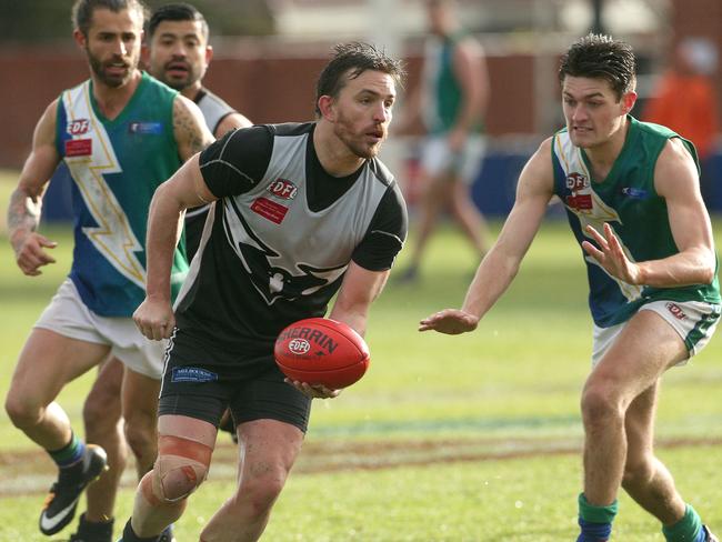 Michael Farrelly of Roxburgh Park handpasses during EDFL Division 2 grand final.