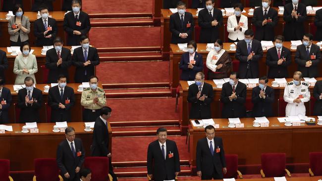 Delegates applaud as Chinese President Xi Jinping, bottom centre, and Premier Li Keqiang, bottom right, arrive for the opening session of China's National People's Congress. Picture: AP