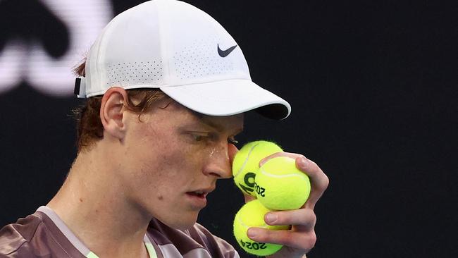 Italy's Jannik Sinner prepares to serve against Russia's Daniil Medvedev during their men's singles final match on day 15 of the Australian Open tennis tournament in Melbourne on January 28, 2024. (Photo by David GRAY / AFP) / -- IMAGE RESTRICTED TO EDITORIAL USE - STRICTLY NO COMMERCIAL USE --