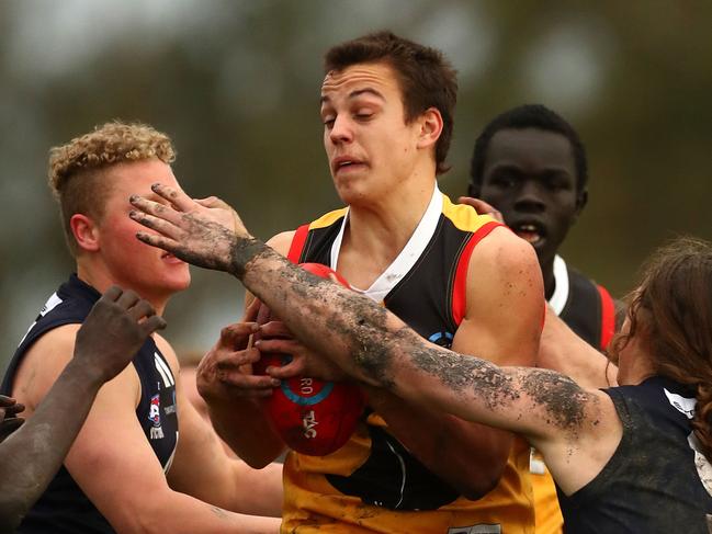 Matthew Gahan of the Stingrays is tackled during the round 11 TAC Cup match between Dandenong and Geelong at Shepley Oval on July 7, 2018 in Melbourne, Australia. (Photo by Kelly Defina/AFL Media)