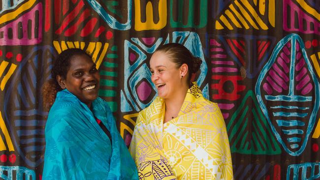 Ash Barty, with local sports star Tarlina Tipungwuti, on a recent trip to the Tiwi Islands for a coaching clinic. Picture: Glenn Campbell