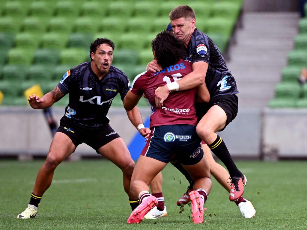 Reds star Jordan Petaia is hit high by the Hurricanes’ Jordie Barrett (right). Picture: William WEST / AFP)