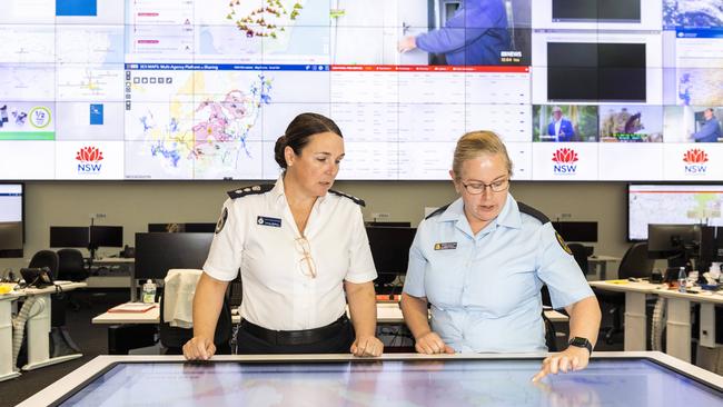 Chief superintendent Laura Wythes and Steph Plattner, senior manager procurement &amp; logisticslooking at the weather and flood updates at the State Emergency Operations Centre. Picture: Monique Harmer