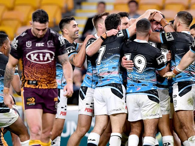 BRISBANE, AUSTRALIA - JULY 31: Braden Hamlin-Uele of the Sharks is congratulated by team mates after scoring a try during the round 12 NRL match between the Brisbane Broncos and the Cronulla Sharks on July 31, 2020 in Brisbane, Australia. (Photo by Bradley Kanaris/Getty Images)