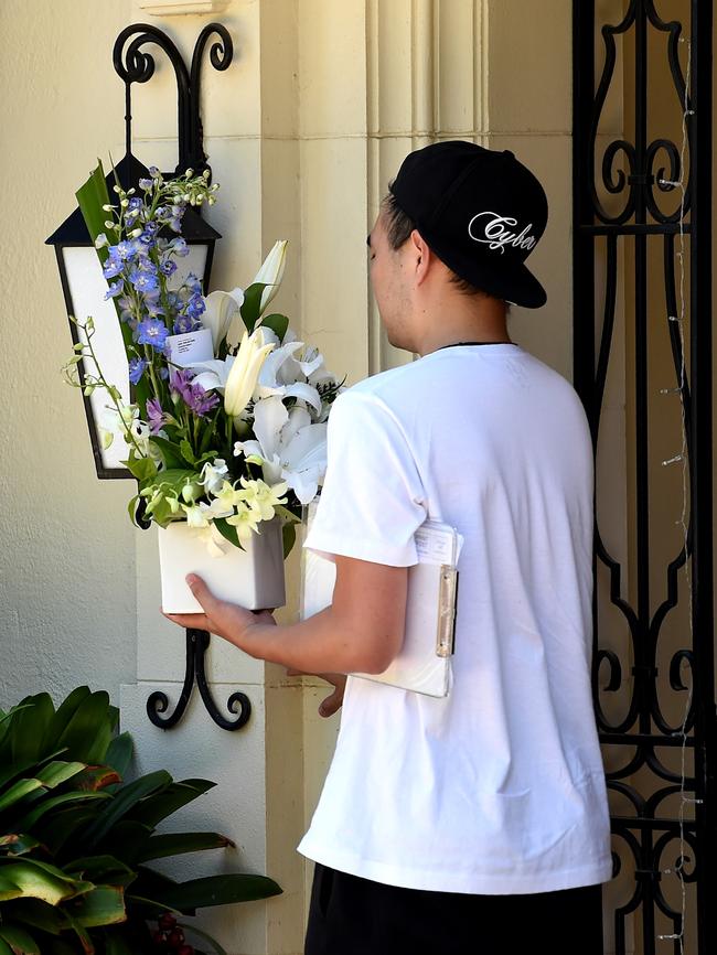 A courier delivers flowers to the Hird family’s Toorak home. Picture: Nicole Garmston