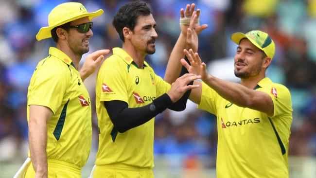 Mitchell Starc celebrates with teammates after the dismissal of India's captain Rohit Sharma. Picture: AFP