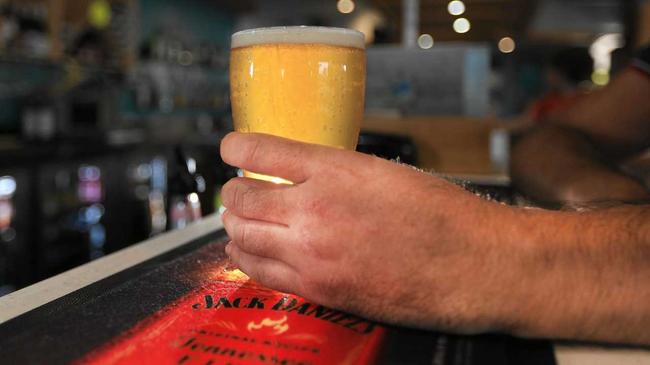 Person drinking beer at the bar. Picture: Scott Powick