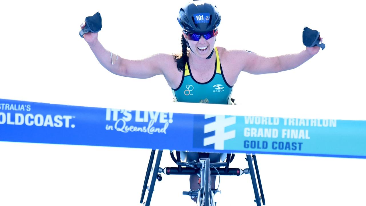 Emily Tapp crosses the line to take out the women’s paratriathlon race on the Gold Coast. Photo: Delly Carr