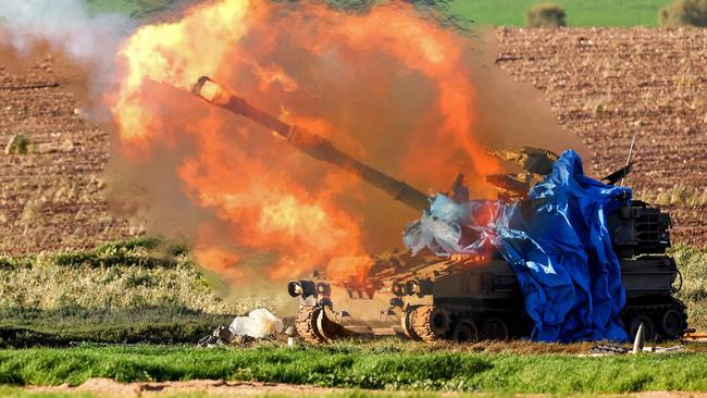 A burst of flame erupts as an Israeli self-propelled Howitzer fires a round from southern Israel toward the Gaza Strip on Wednesday. Picture: AFP