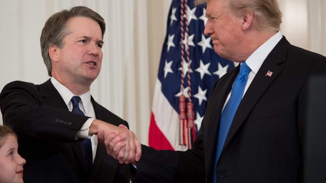 Judge Brett Kavanaugh and US President Donald Trump shake on it at the White House as the judge’s daughter Liza looks on. Picture: AFP