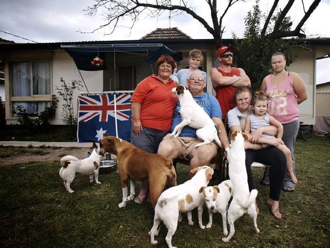 Chloe Kennedy, seated right with child, revealed that people still drive by their house (above) and pelt it with eggs.