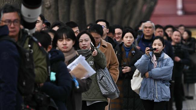 Journalists queue to enter the Great Hall of the People before a press conference for the Chinese People's Political Consultative Conference (CPPCC) in Beijing on March 3, 2025, ahead of the country's annual legislative meetings known as the "Two Sessions". (Photo by Pedro Pardo / AFP)