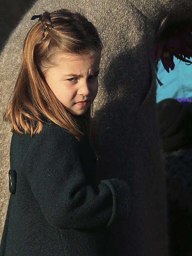 Charlotte greets the public with her mother after attending a Christmas day service. Picture: AP.