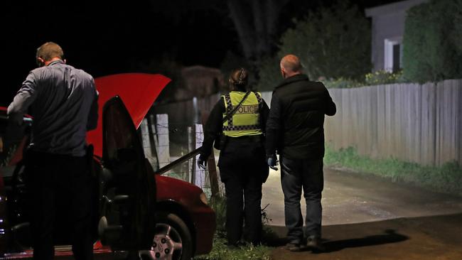 Tasmanian police inspect a property at Magra on Back River Road. Picture: Zak Simmonds