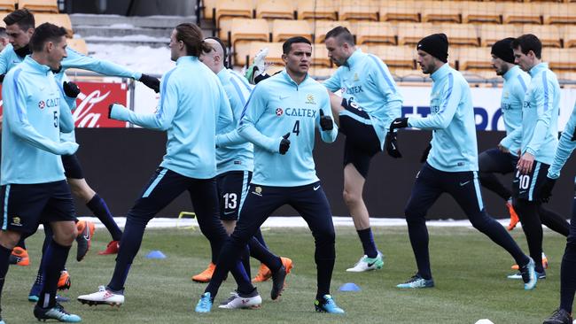 Tim Cahill, centre, warms up with his Socceroos colleagues.