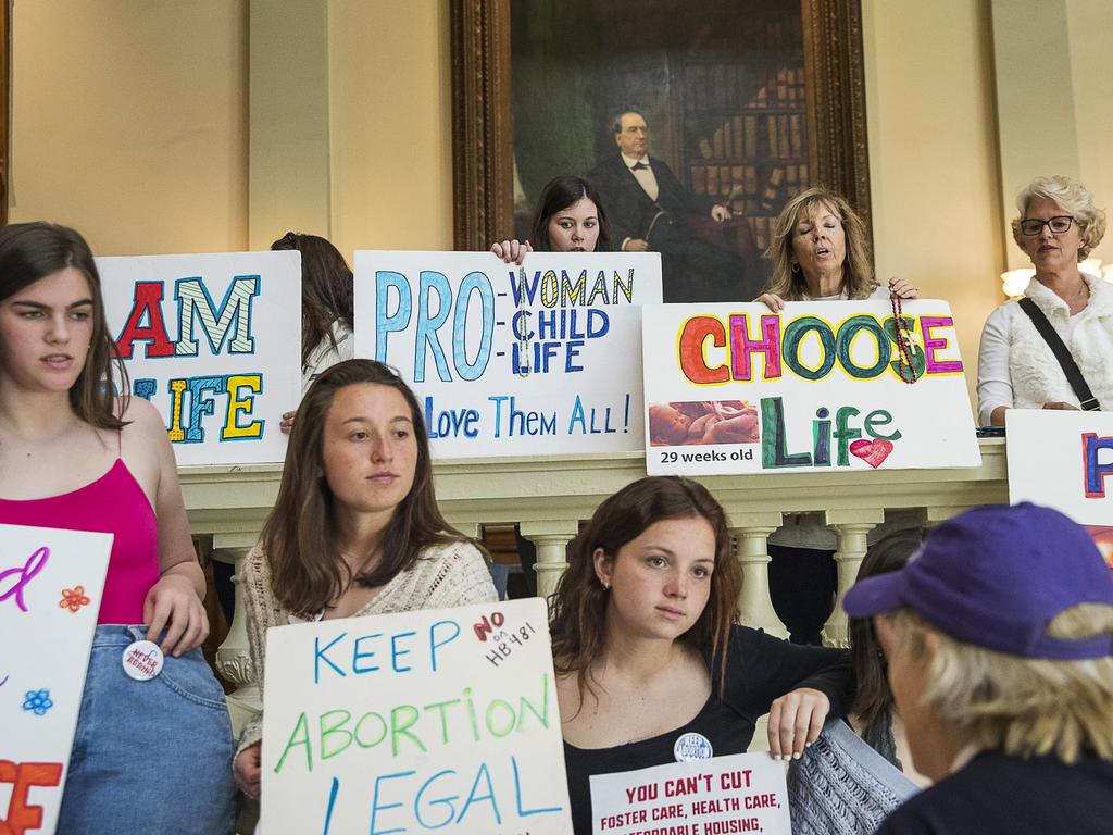 Pro-abortion rights and anti-abortion demonstrators display their signs in the lobby of the Georgia State Capitol building. Picture: AP