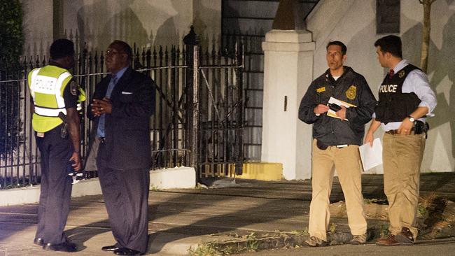 Investigating ... Police stand outside the Emanuel AME Church. Picture: AP