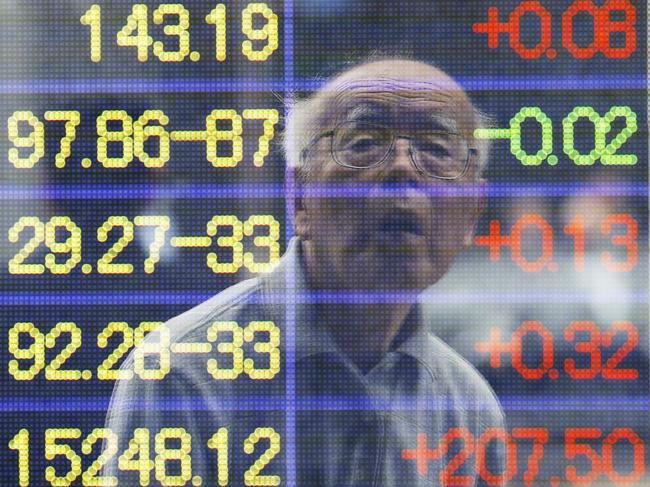 A man is reflected on the electronic board of a securities firm in Tokyo, Monday, June 10, 2013.  Asian markets rose Monday after U.S. jobs data helped allay concern the Fed might wind down its stimulus and Japan's prime minister promised new tax cuts. Tokyo's Nikkei 225, the regional heavyweight, jumped 2.8 percent to 13,245 while Hong Kong's Hang Seng Index added just under 0.1 percent to 21,589.0.  (AP Photo/Koji Sasahara)