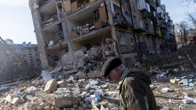 A man walks amid debris in front of a residential apartment complex that was heavily damaged by a Russian attack in Kyiv, Ukraine. Picture: Getty