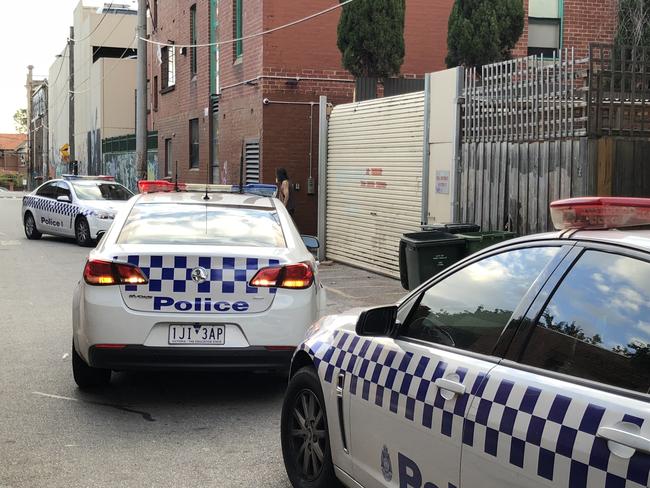 Police cars outside the Regal after a man was stabbed there on March 12.