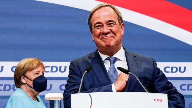 Christian Democratic Union (CDU) party chairman Armin Laschet speaks to supporters as German Chancellor Angela Merkel looks on. Picture: Getty Images