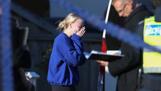 A shocked woman weeps at the scene. Picture: Brendan Beckett