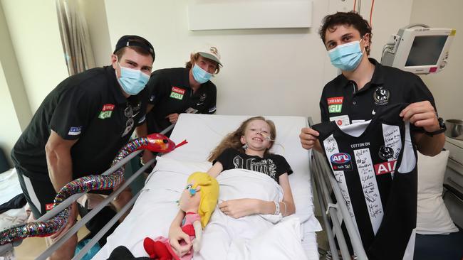 Collingwood AFL players Mason Cox, Nathan Murphy and Trent Bianco visit Danielle Sedgwick, 15, from Albury. Picture: Alex Coppel