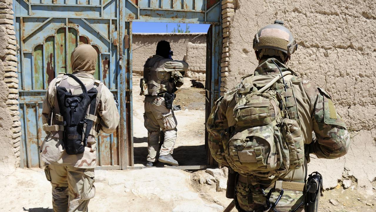 An Australian Army soldier from Special Operations Task Group (right) provides cover for Afghan National Security Force personnel leading the clearance of a compound of interest in Afghanistan. Picture: Department of Defence