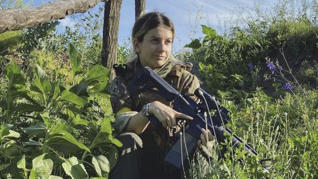 Emese Fajk, who allegedly tried to con the Nine Network show The Block, appeared at a press conference alongside three foreign fighters at the ‘Ukraine Media Centre’ and was pictured holding what appears to be an M4A1 assault rifle.