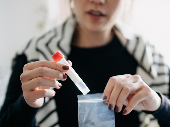 Cropped shot of young Asian woman consulting to her family doctor online in a virtual appointment, holding a medical test tube, conducting Covid-19 diagnostic test at homecredit: getty imagesescape1 august 2021doc holiday