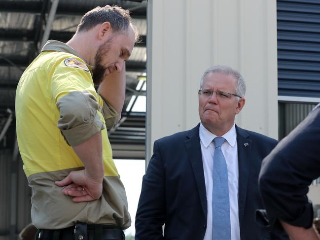 Prime Minister Scott Morrison speaks to Levi Roberts (left) from NSW Parks and Wildlife during his visit to Huonville on Monday, February 4. Picture: LUKE BOWDEN