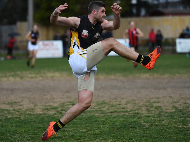 Balwyn defedner Kris Pendlebury sends the ball back the other way. Picture: James Ross/AAP