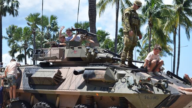 Fire fans Jack Turner and Cameron Douglas check out the view from the top of an army tank at Townsville Entertainment Centre. Picture: Nikita McGuire