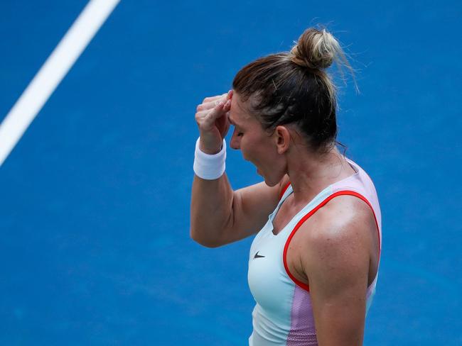 Simona Halep of Romania reacts as she plays against Daria Snigur of Ukraine during their 2022 US Open Tennis tournament women's singles first round match at the USTA Billie Jean King National Tennis Center in New York, on August 29, 2022. (Photo by KENA BETANCUR / AFP)