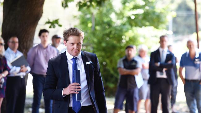 There were plenty of onlookers at the Bayswater Wine Cellars auction, but Colliers International auctioneer Richard Wilkinson failed to find a buyer. Picture: Steve Tanner