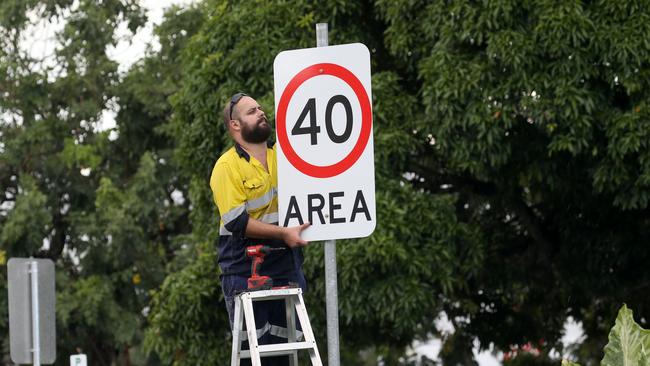 A council worker putting up a 40km/h speed limit sign. Picture: Anna Rogers