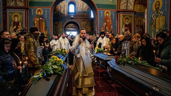 An Orthodox priest leads a memorial service for volunteers in Kyiv’s Saint Michael's Golden-Domed Monastery on Tuesday. Picture: AFP