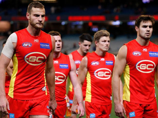 Suns players leave the field after the Round 20 AFL match between the Melbourne Demons and the Gold Coast Suns at the MCG in Melbourne. Picture: AAP Image/Daniel Pockett.