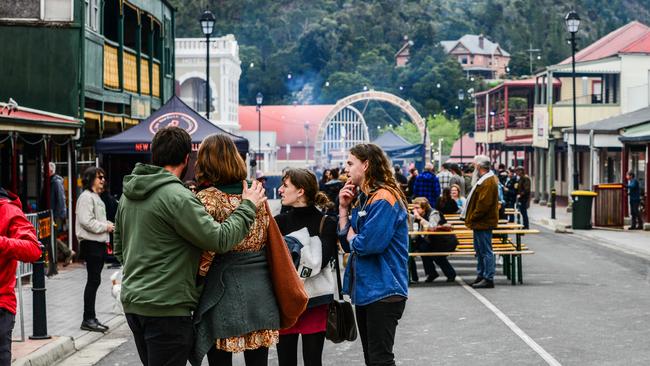 Festival goers console each other in Queenstown's main St as the Unconformity Festival was cancelled. Picture: Chris Crerar