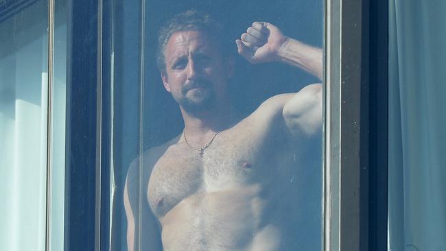 US player Tennys Sandgren, in Melbourne for the Australian Open, raises a fist in defiance from his hotel quarantine. Picture: Josie Hayden