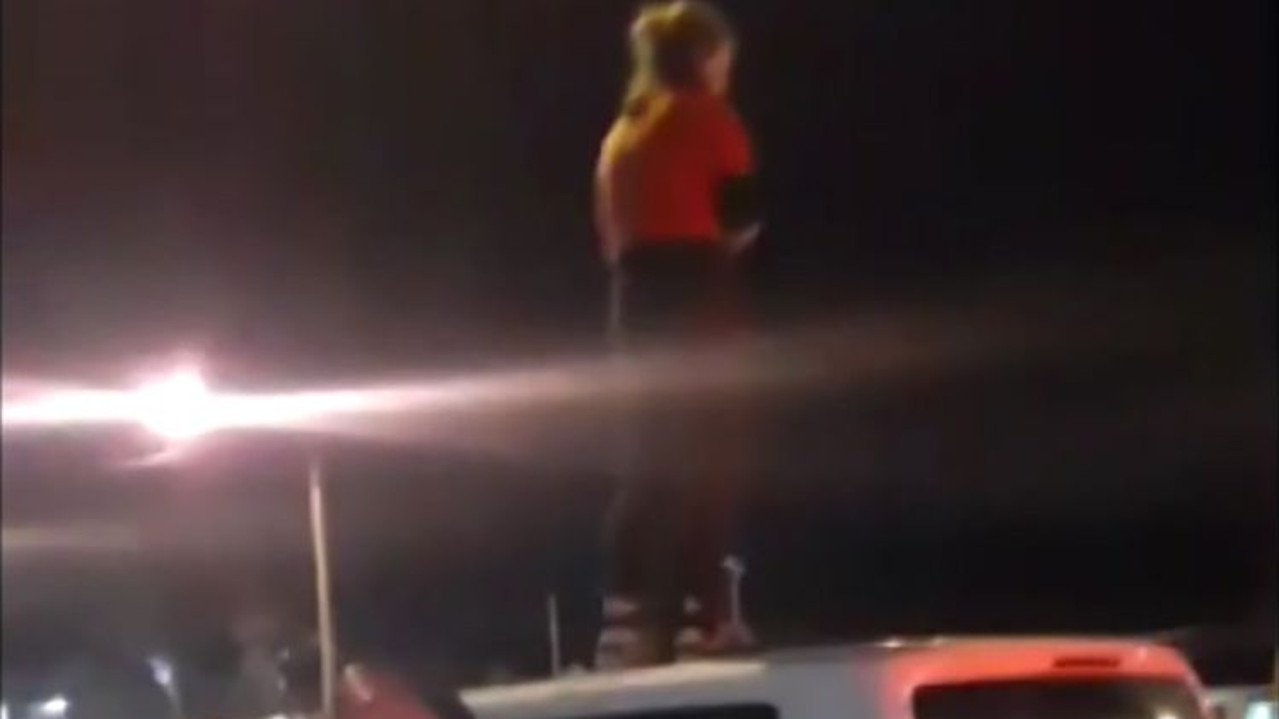 A protester jumped on top of a van to stop it moving, as it had a refugee inside.