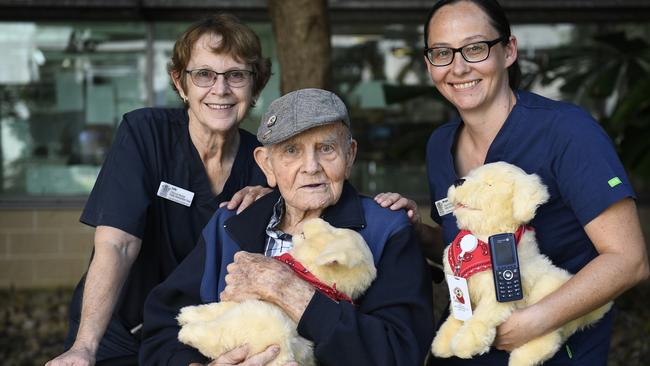 Townsville University Hospital frailty intervention clinical nurse Judith Mercer, stroke survivor Keith Griffiths, 95, and nurse Morgan Anderson. The trio are pictured with Lewy, a member of the TUH frailty intervention team who was recruited to help care for patients living with Alzheimer's disease or dementia. Picture: Supplied